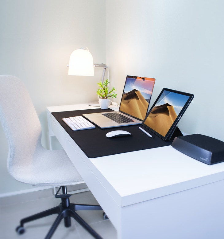 A Laptop and a tablet on a white desk